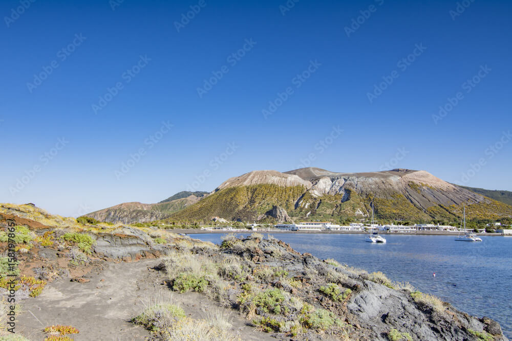 catamarans anchored in vulcano levante bay with the crater in the background