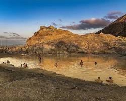 people bathing in the mud lake in vulcano isle