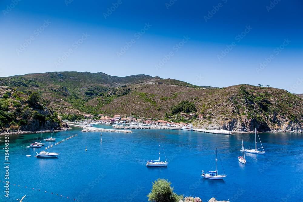 Boats at anchor Capraia port Tuscan sailing