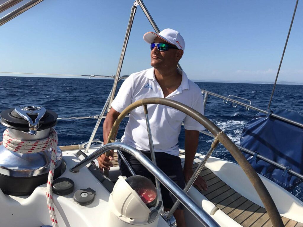 Certified professional skipper steering a luxury catamaran during a private sailing cruise with MySailCruise.