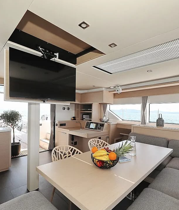 Elegant interior living and dining area aboard a luxury catamaran – MySailCruise