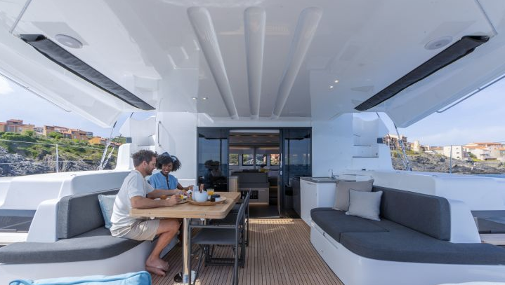 Luxury catamaran outdoor living area with comfortable seating – MySailCruise