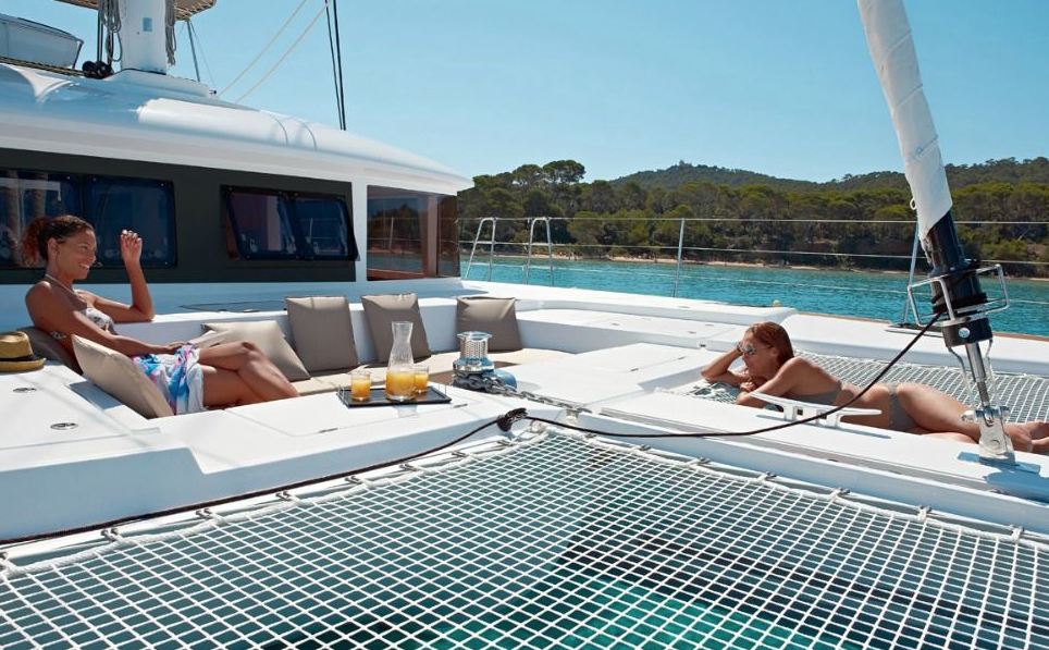 Spacious deck and sunbathing area aboard a luxury catamaran – MySailCruise